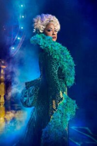 Madame Morrible Dressed as Madame Morrible, in green gown with feathers around her neckline